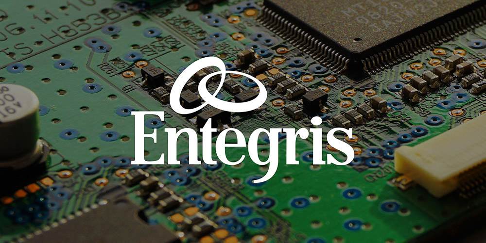 Entegris logo over circuit board photo